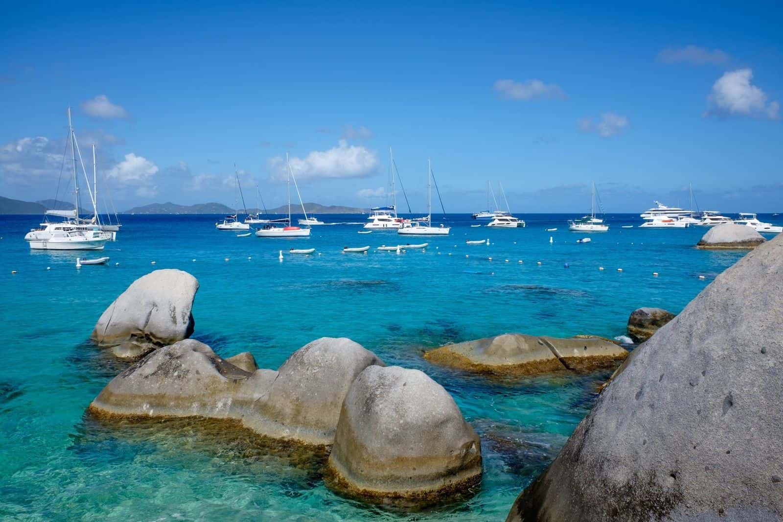 Devil's Bay, Virgin Gorda: rounded granite boulders in clear turquoise water, sailboats offshore