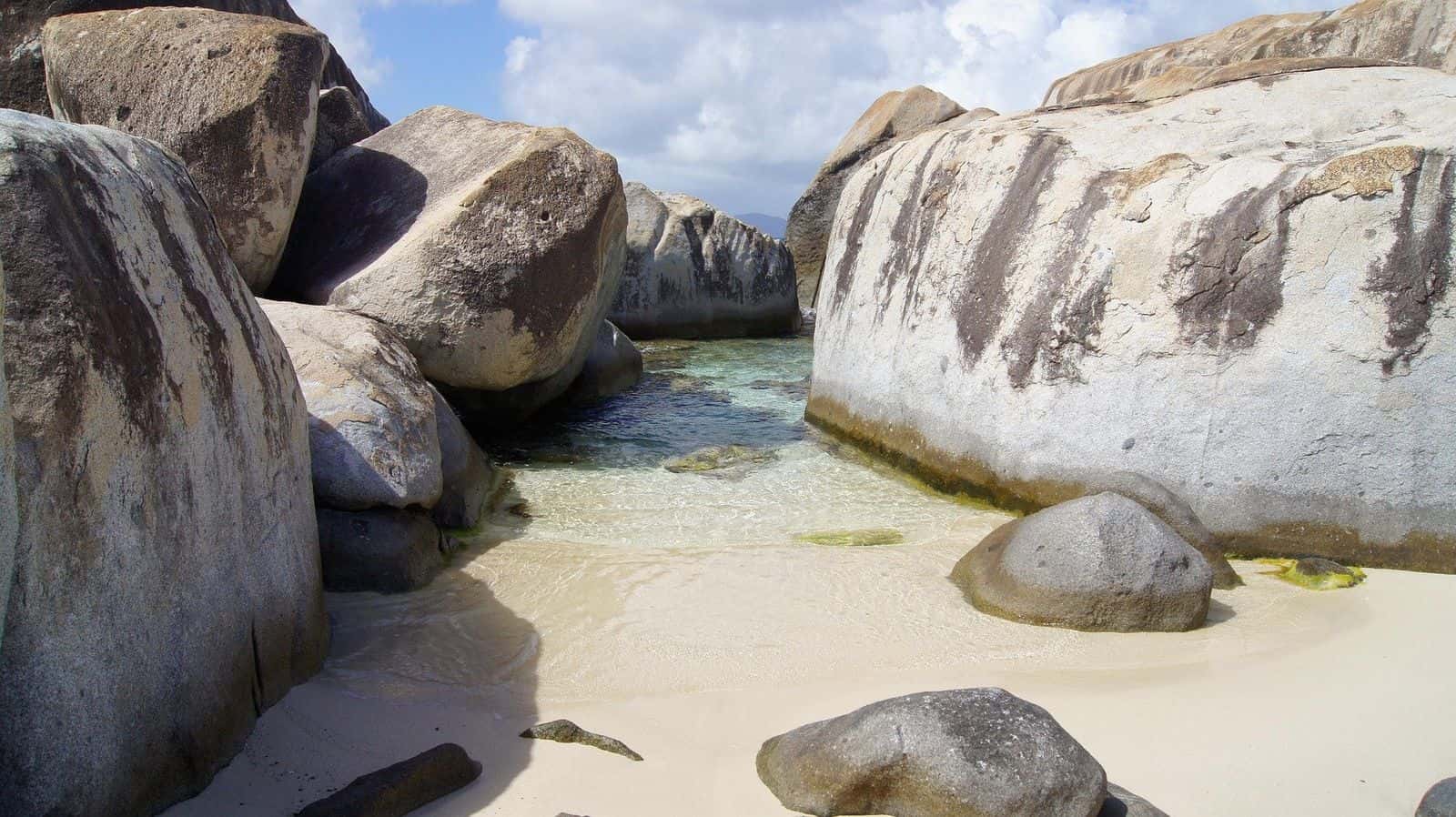 Spring Bay, Virgin Gorda: a small sandy cove and shallow pool between huge granite boulders