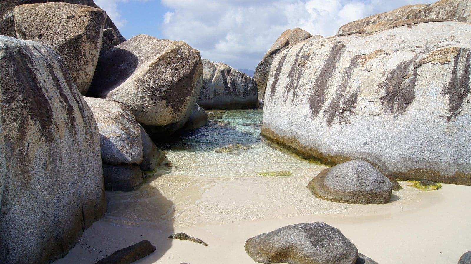 Spring Bay, Virgin Gorda: a small sandy cove and shallow pool between huge granite boulders
