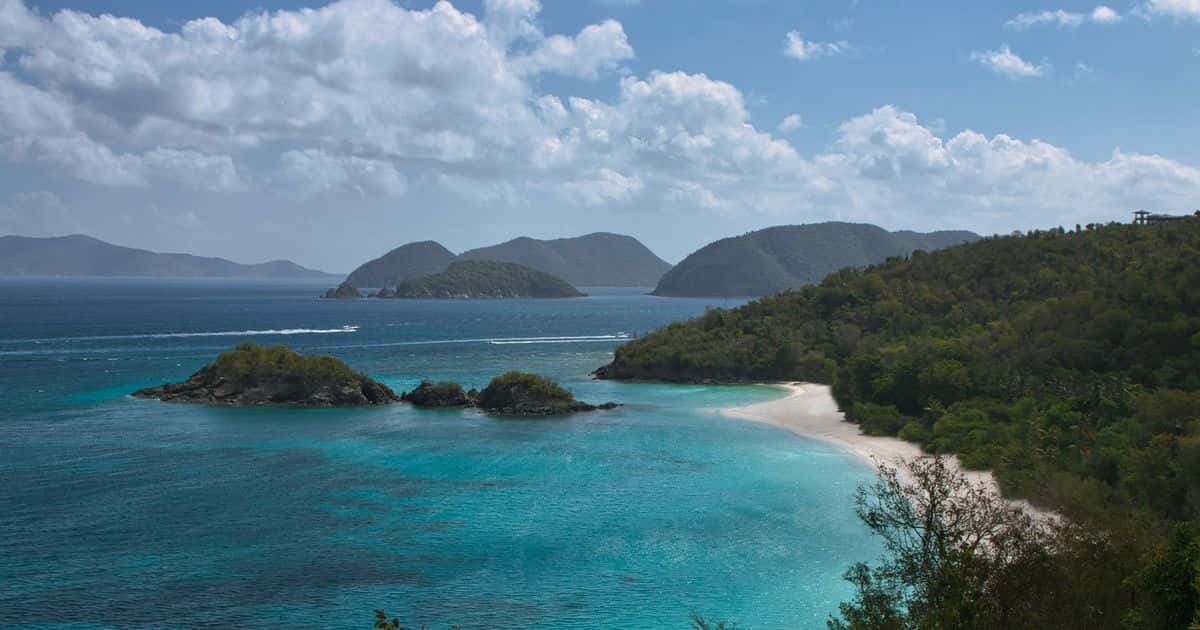 Trunk Bay and Trunk Cay from the North Shore Road overlook on St. John, under broken cloud.