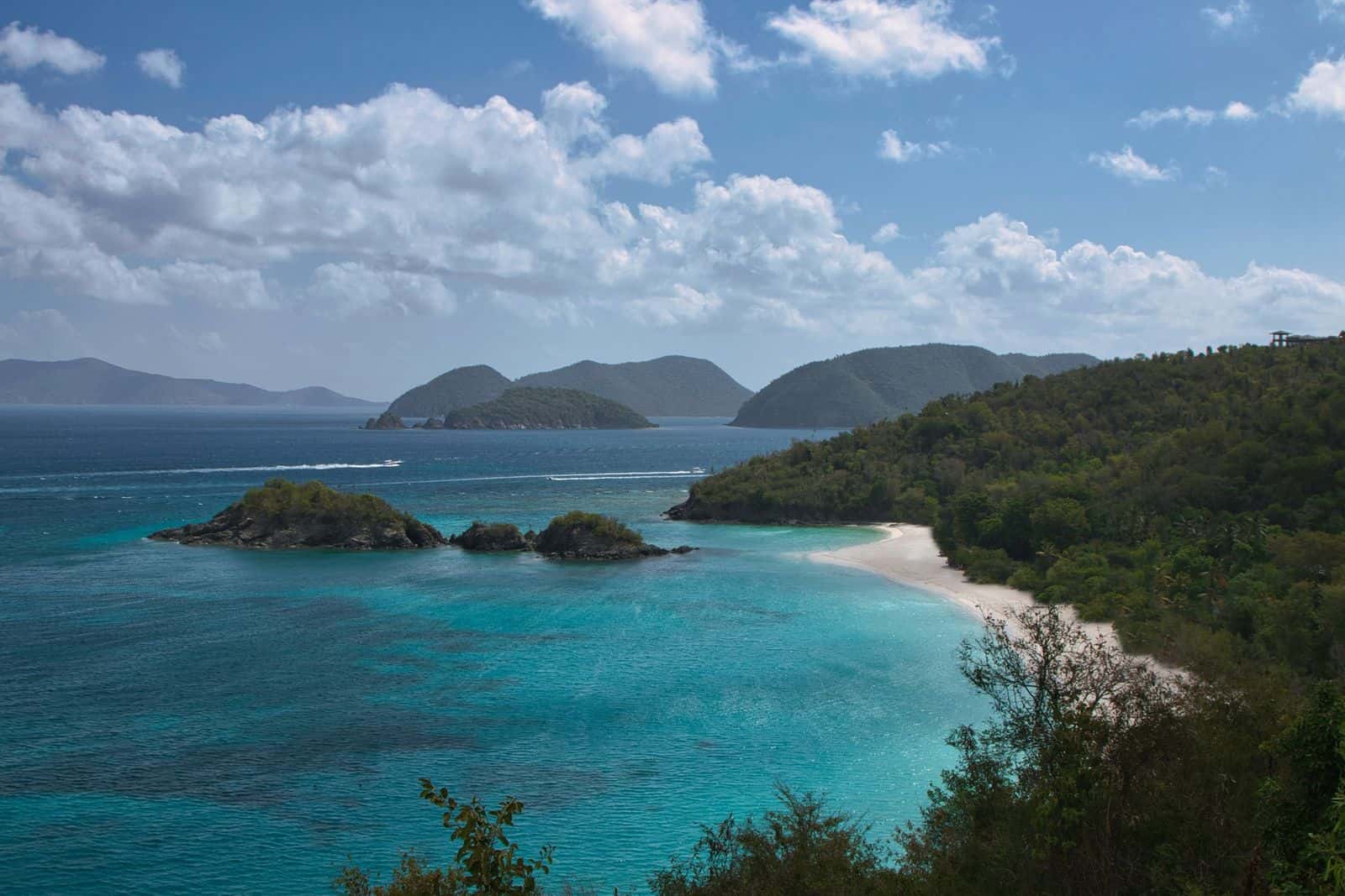 Trunk Bay and Trunk Cay from the North Shore Road overlook on St. John, under broken cloud.