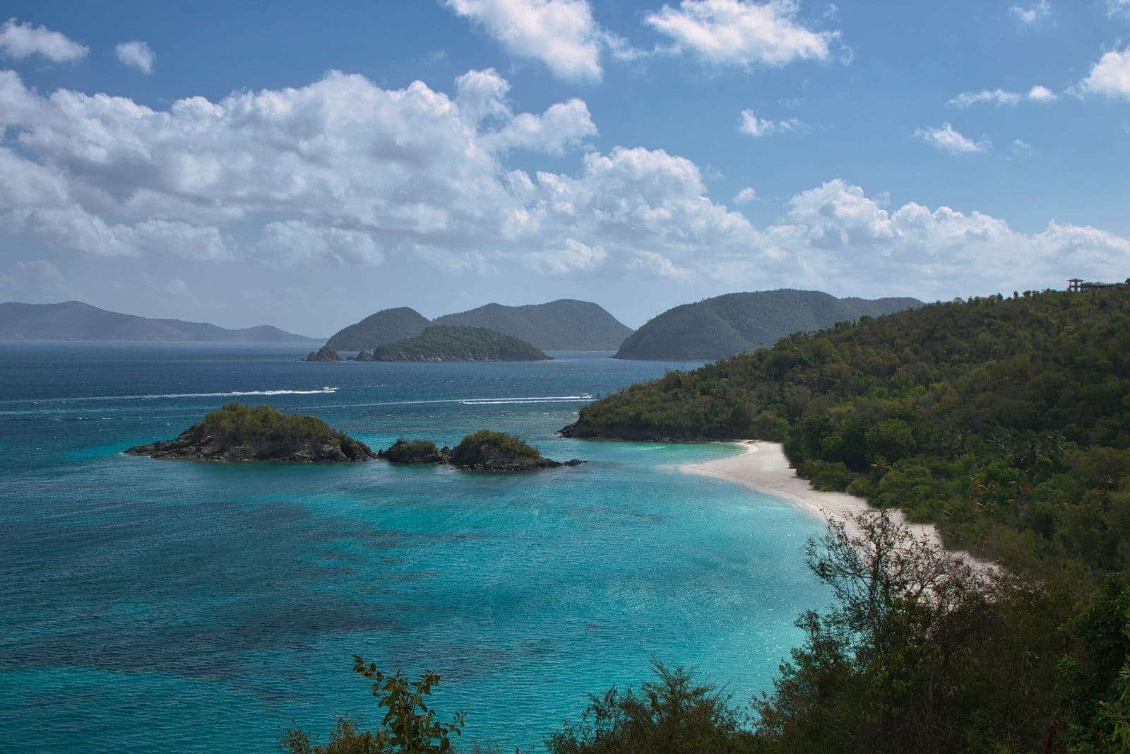 Trunk Bay and Trunk Cay from the North Shore Road overlook on St. John, under broken cloud.