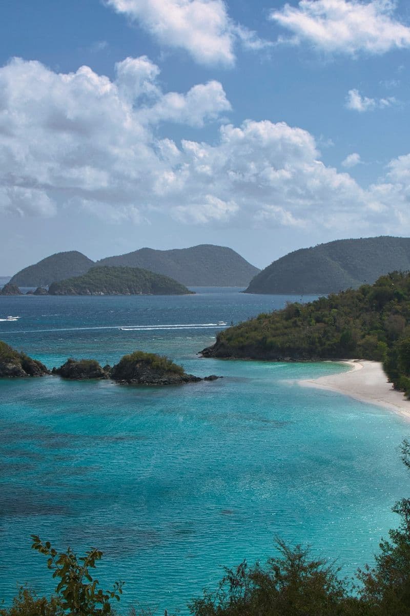 Trunk Bay and Trunk Cay from the North Shore Road overlook on St. John, under broken cloud.