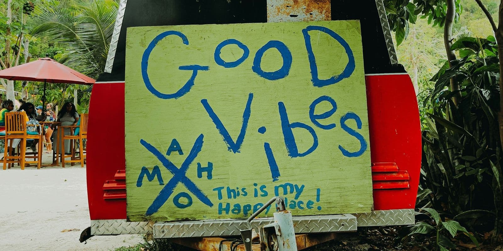 A hand-painted "Good Vibes" sign marked MAHO on the back of a trailer at Maho, St. John.