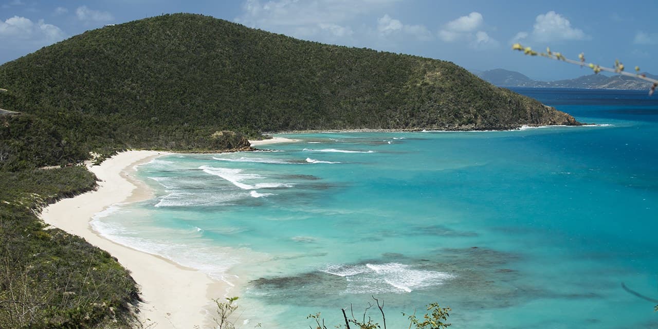Savannah Bay, Virgin Gorda, from the overlook: white beach, reef-streaked water, a green headland